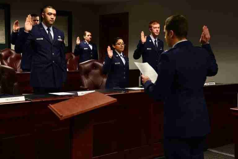 Uniformed individuals taking an oath to tell nothing but the whole truth in a formal ceremony.