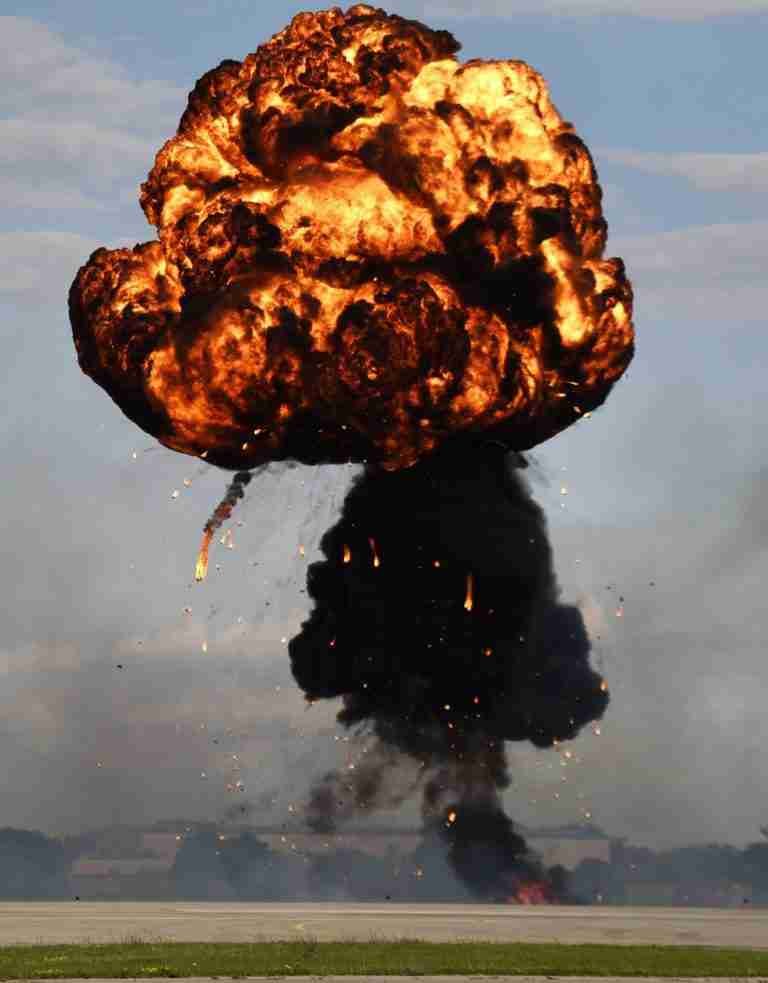 A massive fireball explodes into the sky, sending plumes of smoke and flames upwards, creating a dramatic and intense spectacle. Big Bang Theory Truth